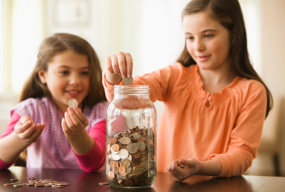 Two girls collecting coins together