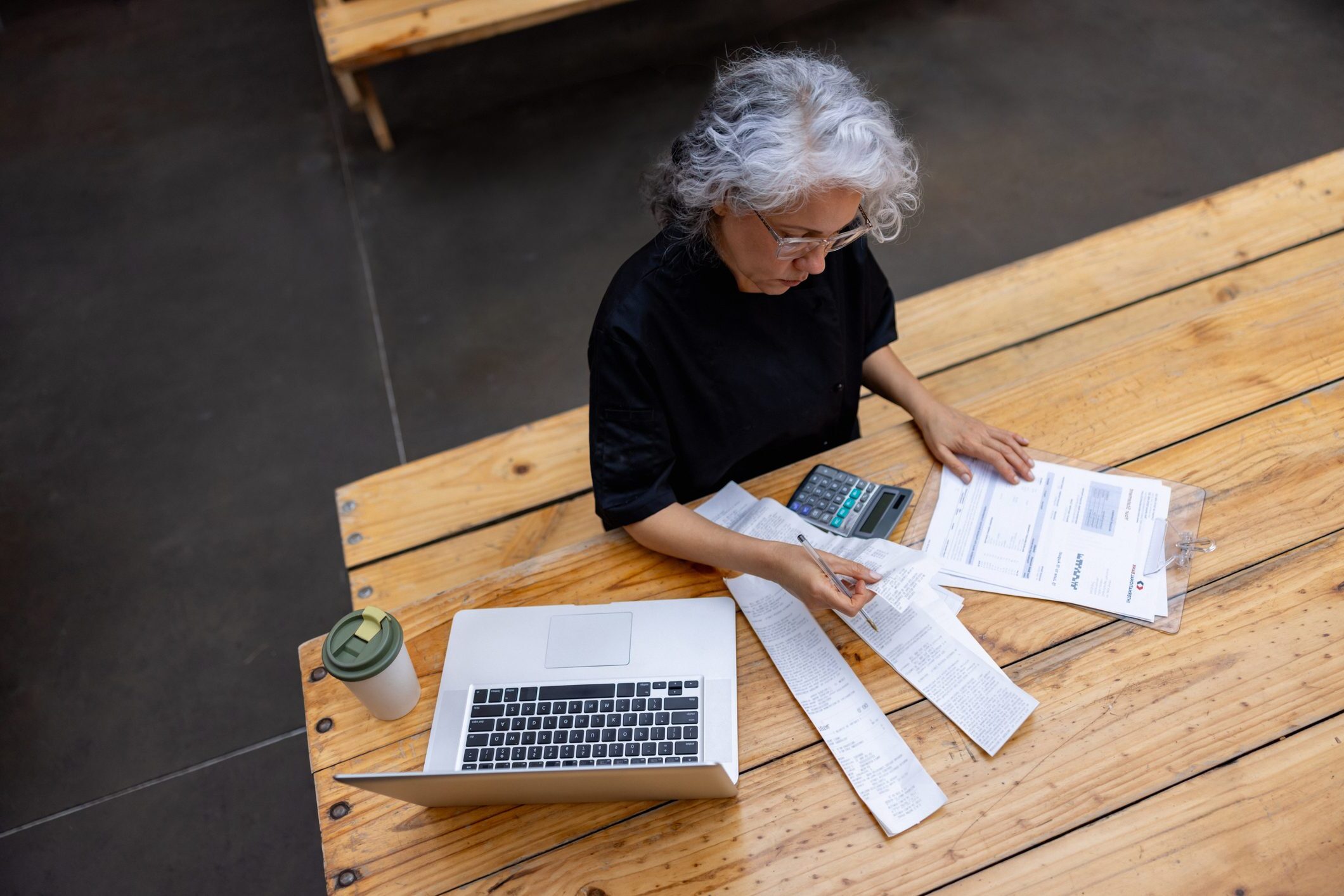 Latin American business owner and chef bookkeeping at a restaurant after closing - small business concepts